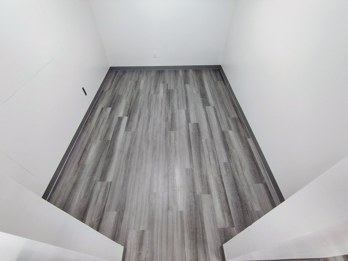 Gray vinyl plank flooring installed in a hallway in Rochester NY