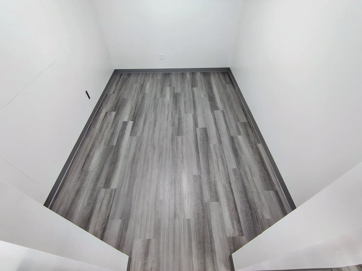 Gray vinyl plank flooring installed in a hallway in Rochester NY