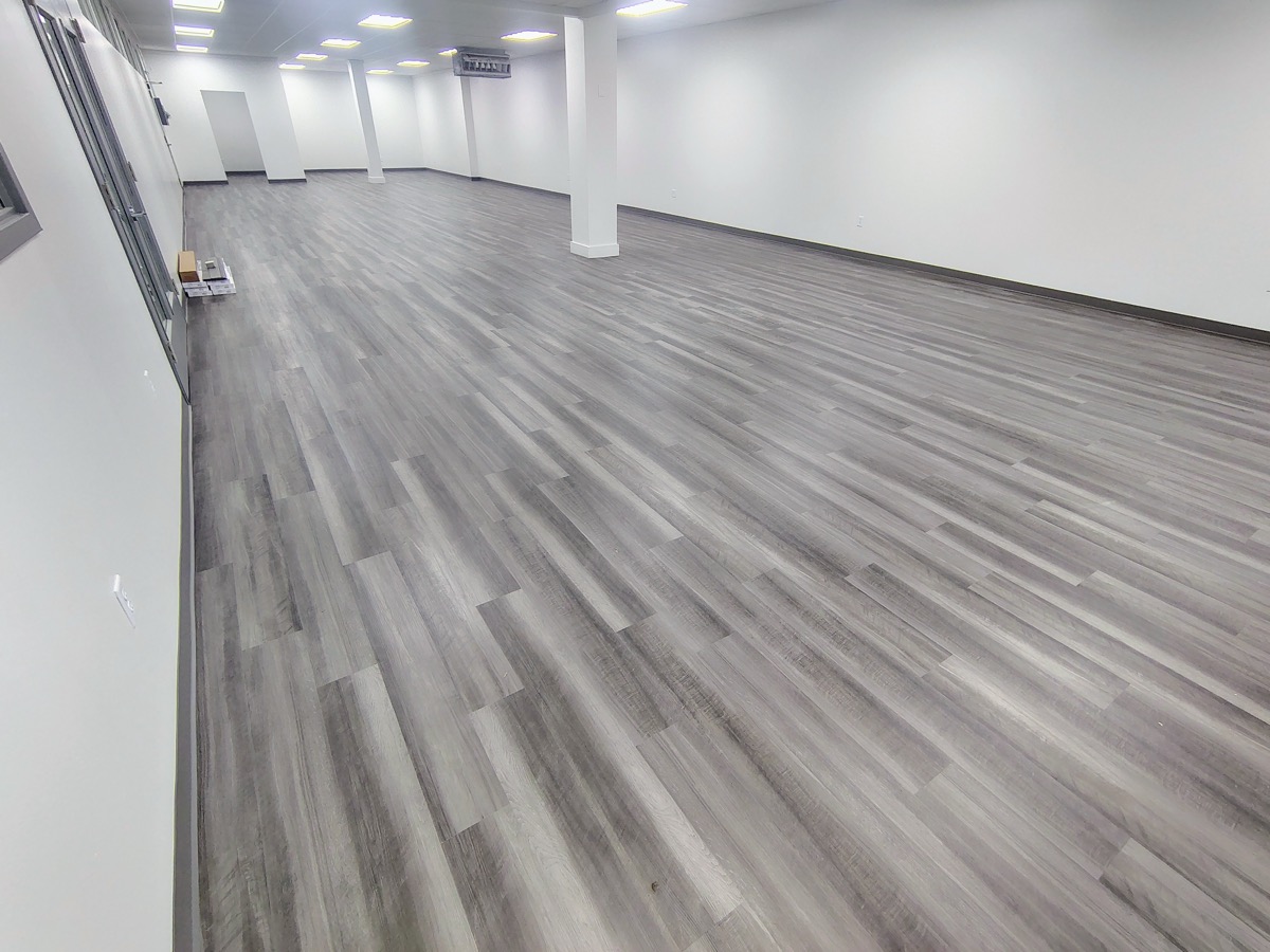 Grey vinyl plank flooring installed in a large commercial space