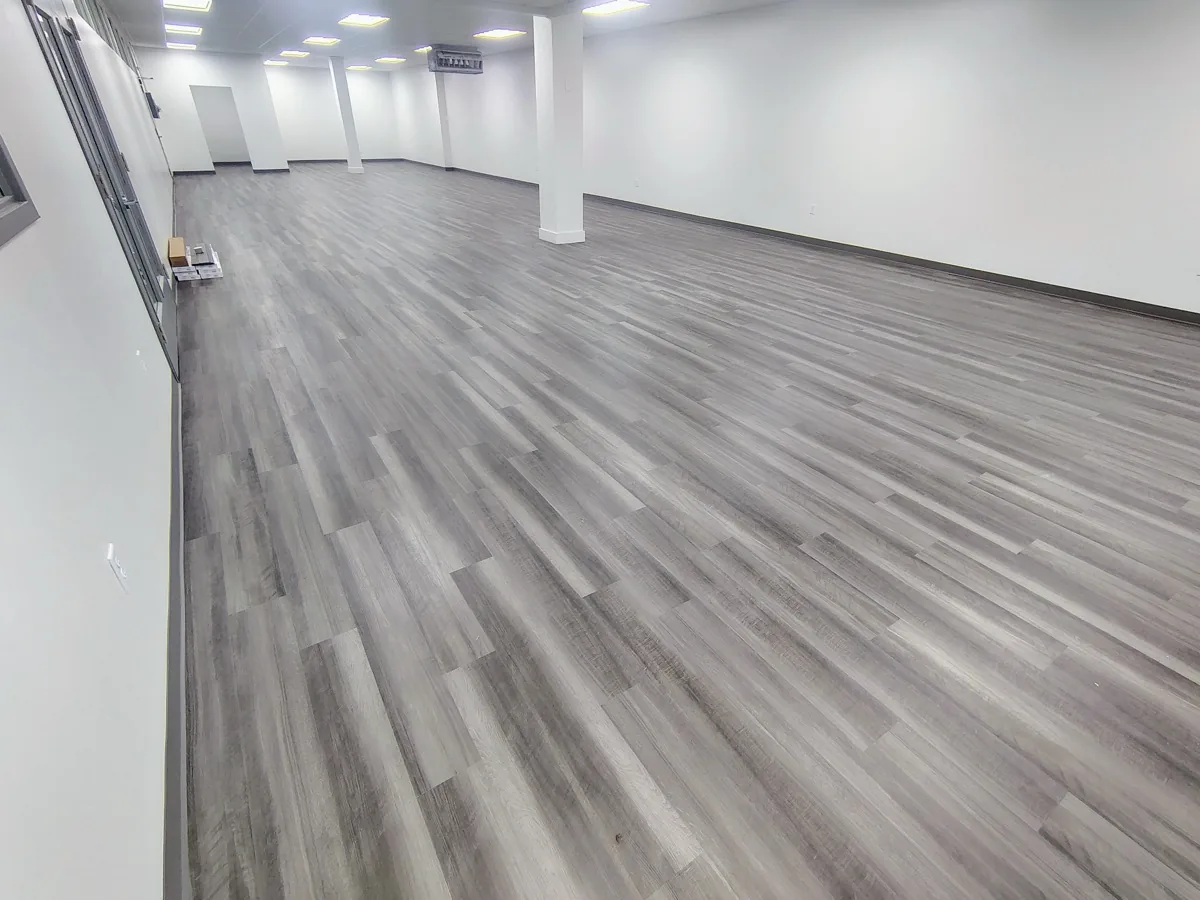 Grey vinyl plank flooring installed in a large commercial space